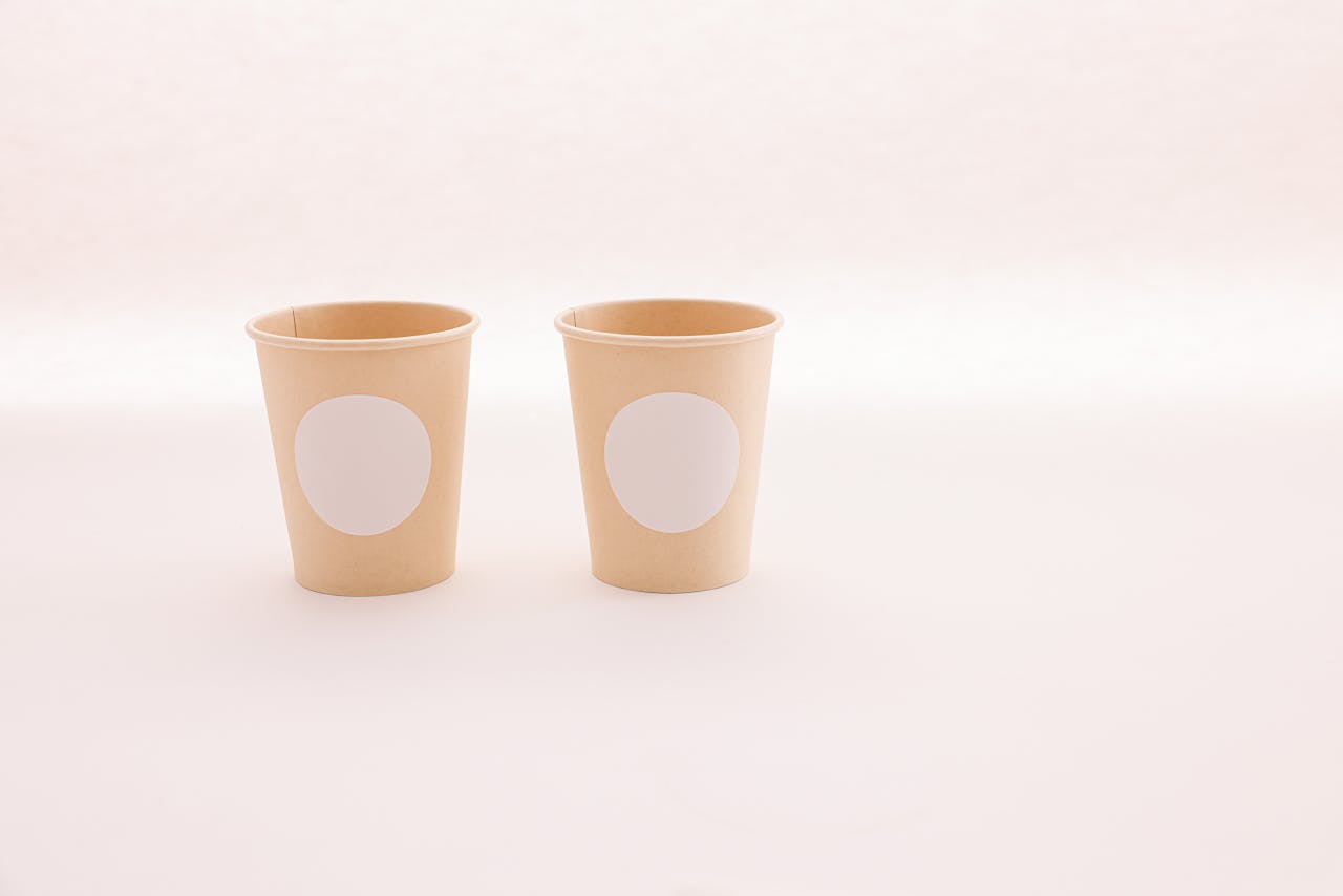 Simple and clean image showcasing eco-friendly disposable paper cups with minimalist design for mockup.